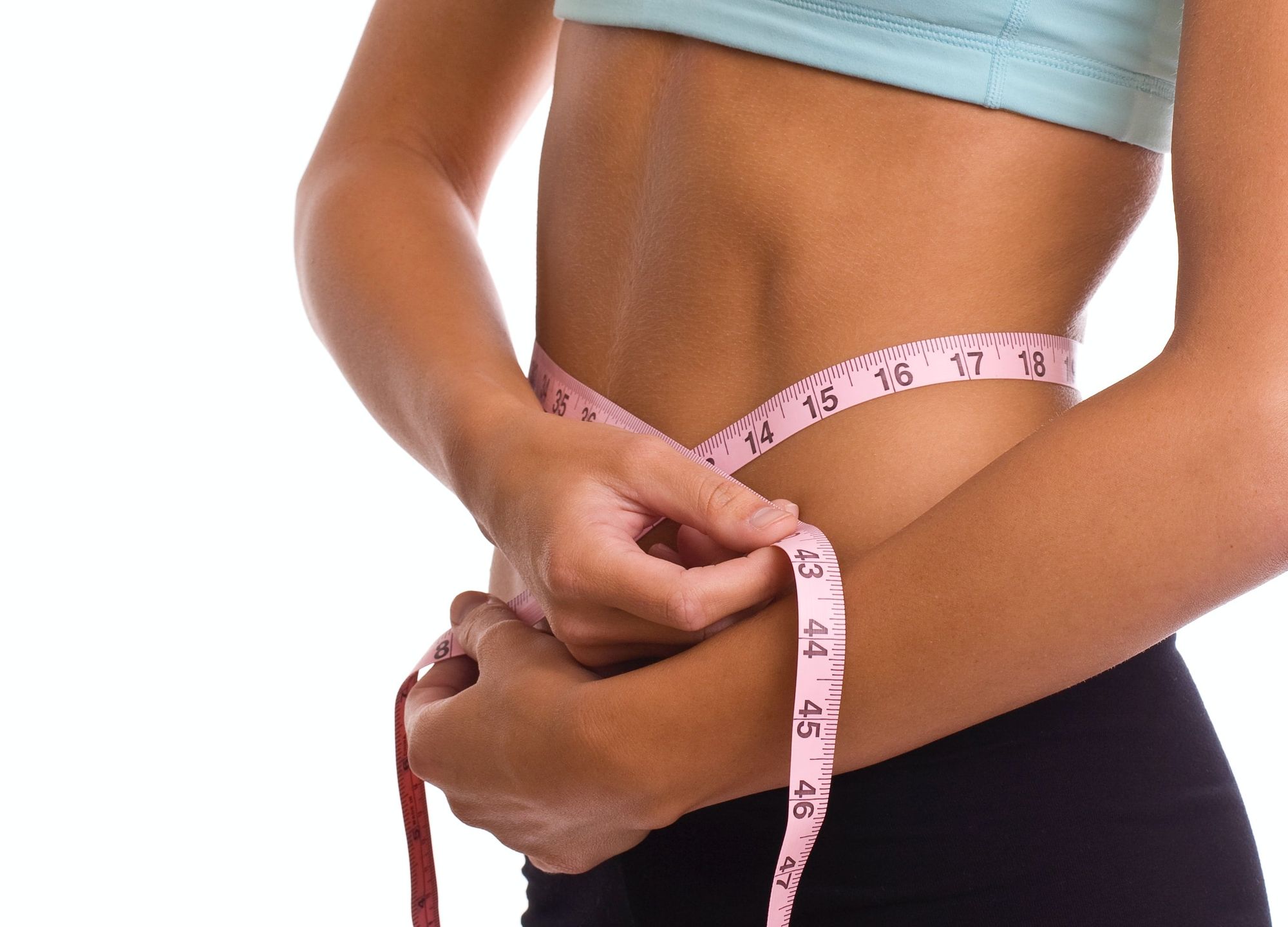 Lady measuring her waist.