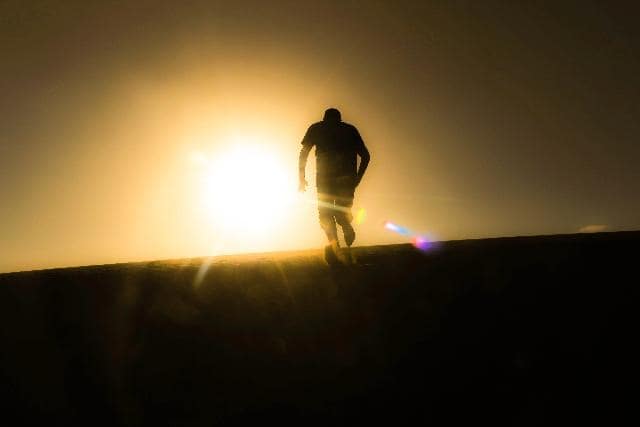 Man walking toward the sun and back to God.