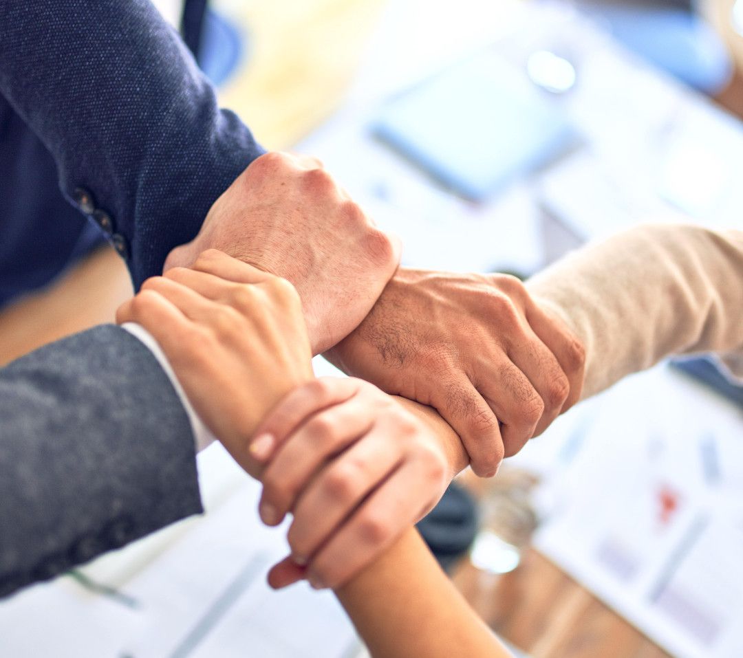 Group of people holding hands. Shift4Shop interests are aligned with yours and they will diligently support you all the way because if you win then they win too.