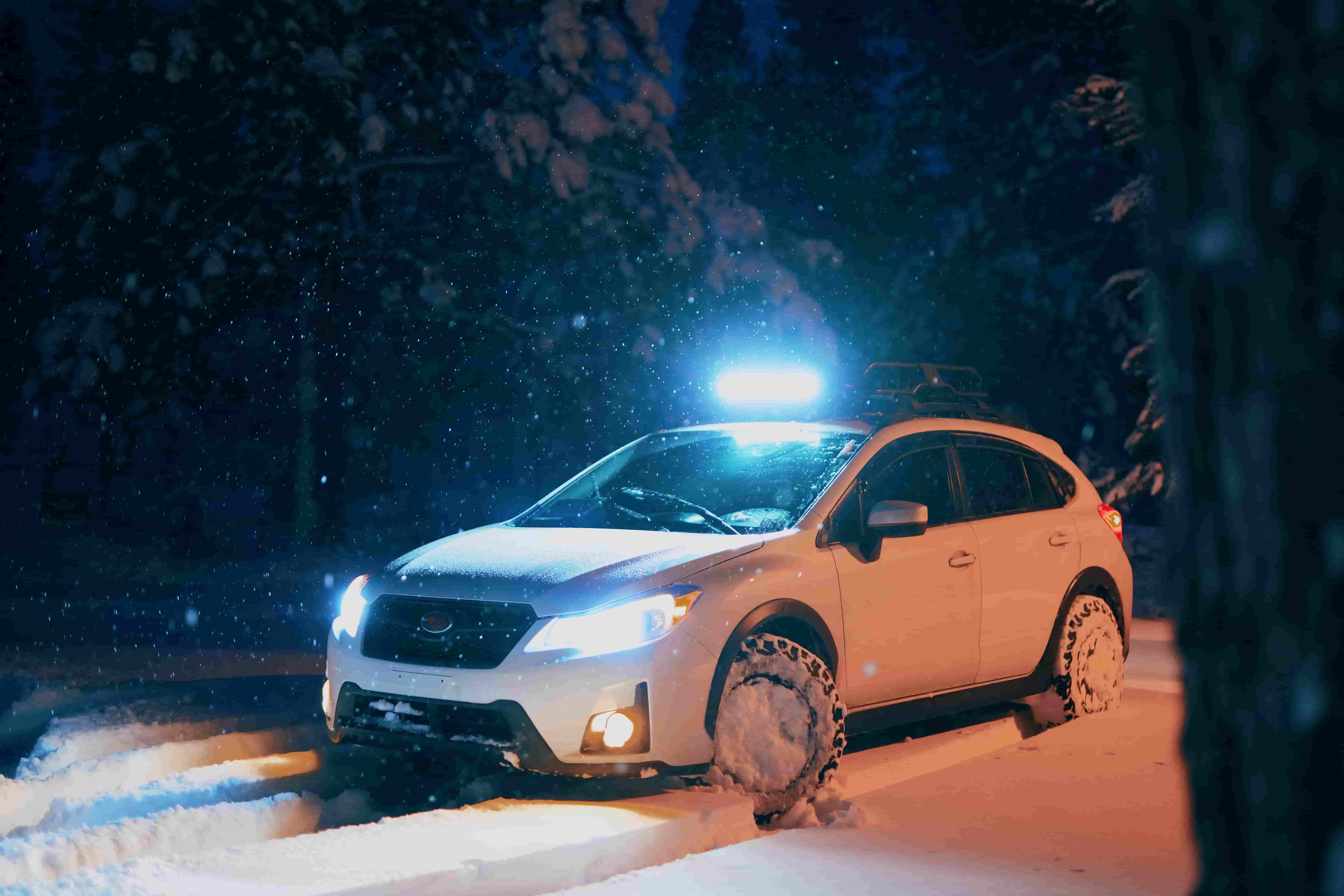 Car stuck in snow at night.