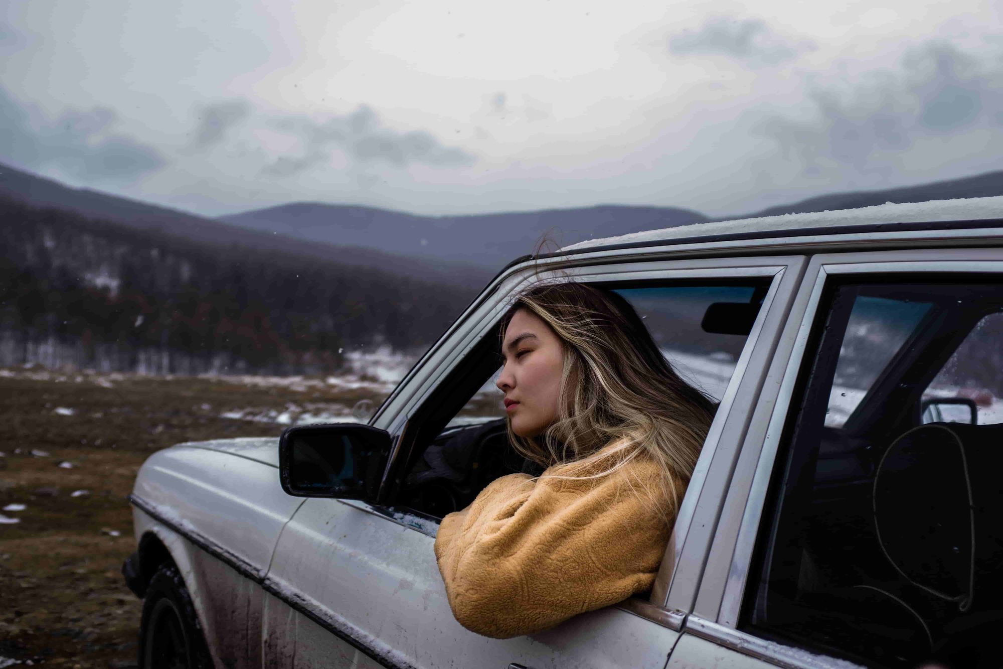 Woman in car. Emergencies can happen anywhere. Keeping the best survival bivy with you can be a lifesaver.