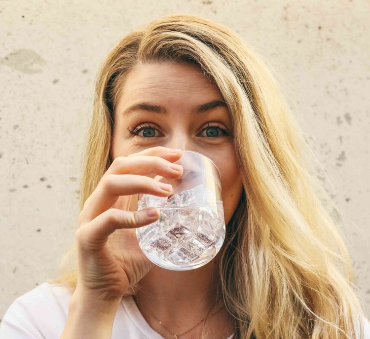 Lady drinking pure water.